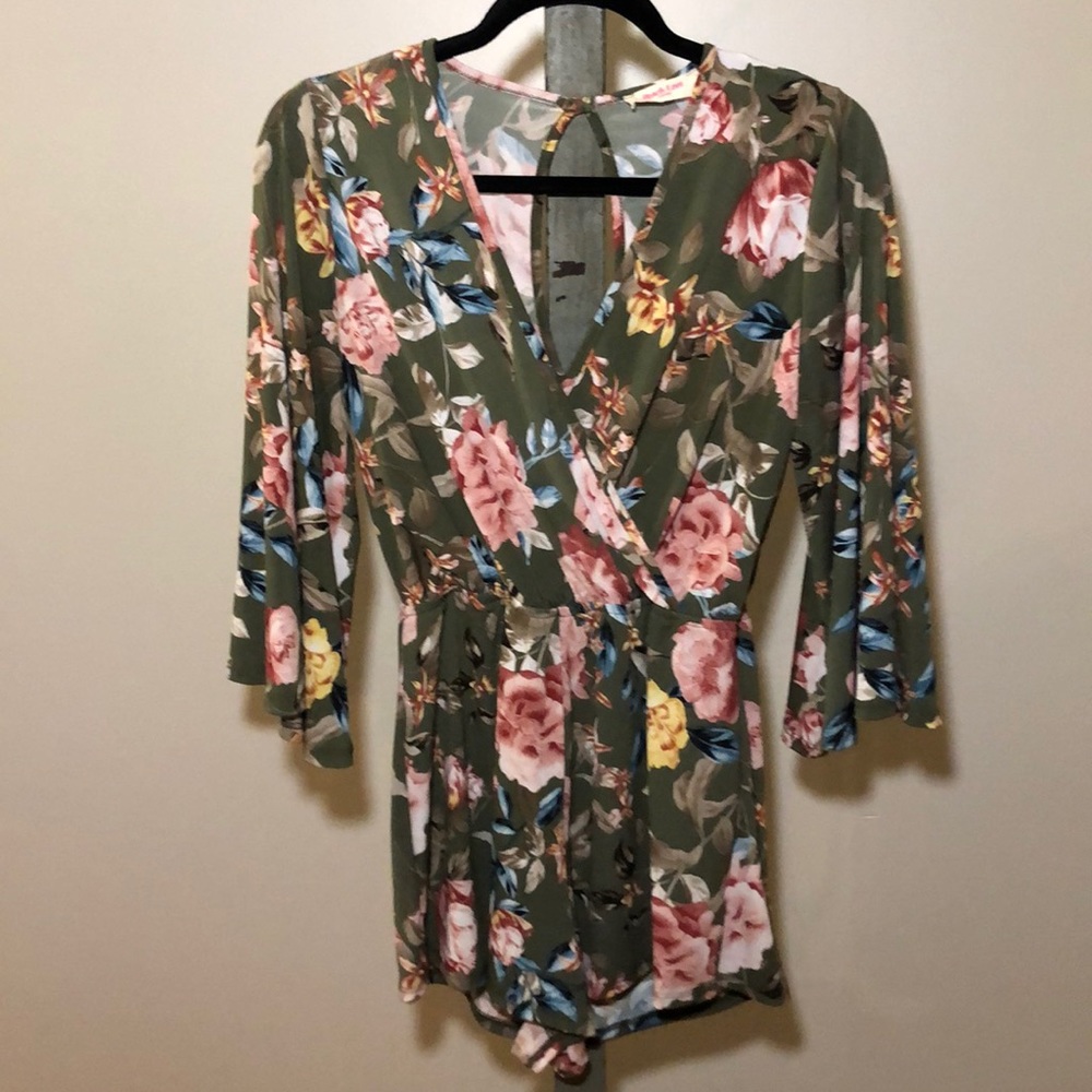 Green floral romper with bell sleeves.
